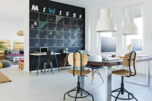 Modern commercial office with chalkboard calendar, minimalist desks, and contemporary decor used for staging design